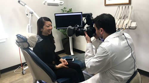 Woman getting photo taken of her teeth