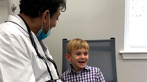Doctor sitting with kid smiling