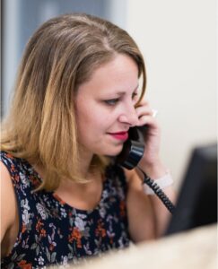 Women using phone at front desk 