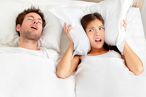 man snoring in bed