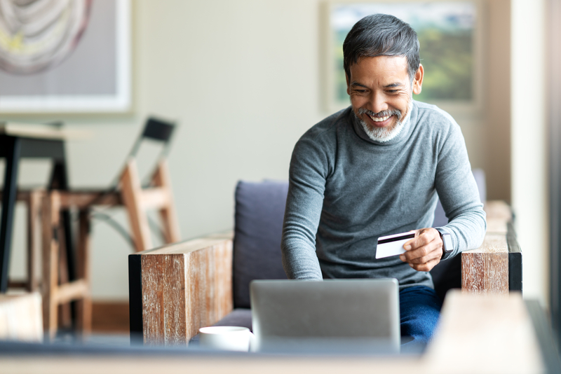 man smiling at a computer