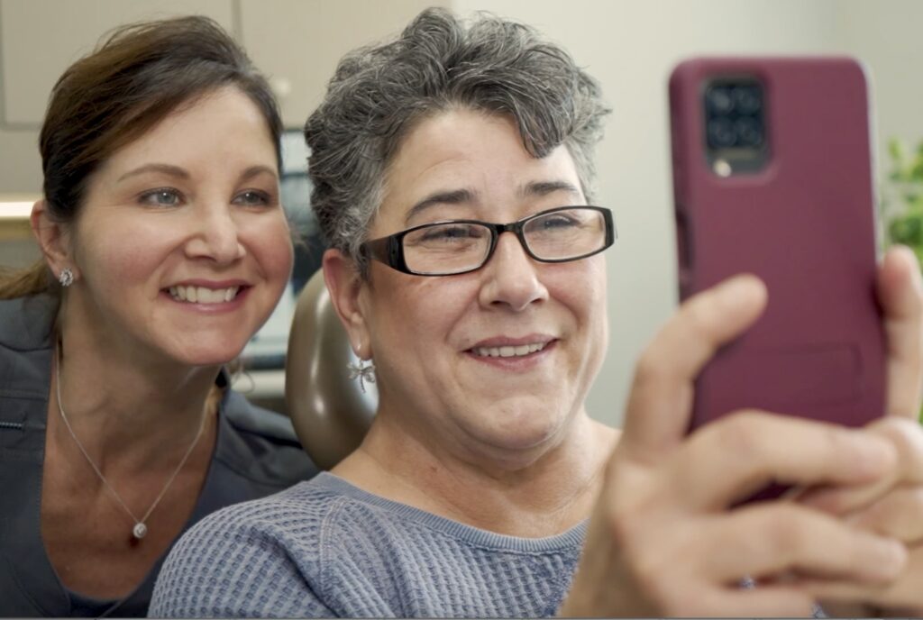 people smiling at a phone